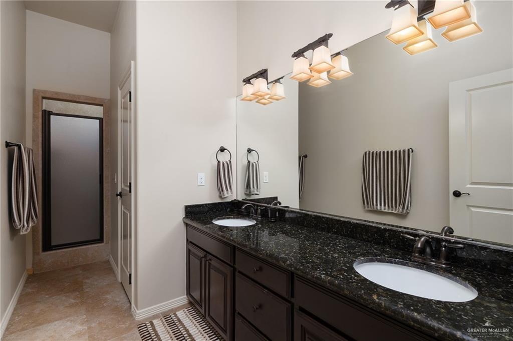 605 Ithaca Avenue McAllen, TX 78501 - Photo 12 of 23 a bathroom with a granite countertop sink and a mirror