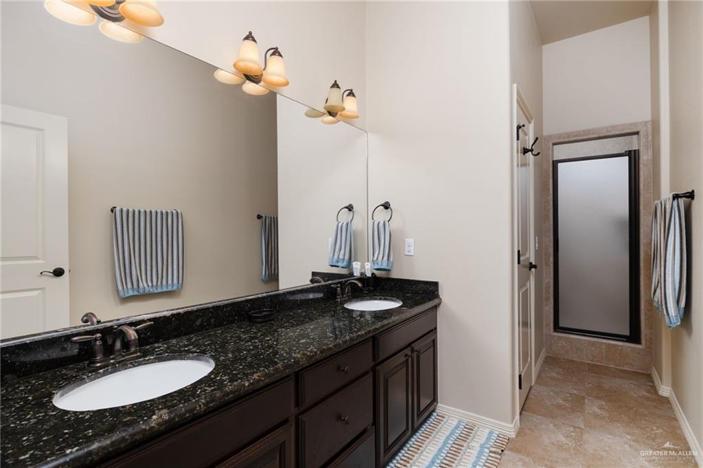 605 Ithaca Avenue McAllen, TX 78501 - Photo 14 of 23 a bathroom with a granite countertop sink and a mirror