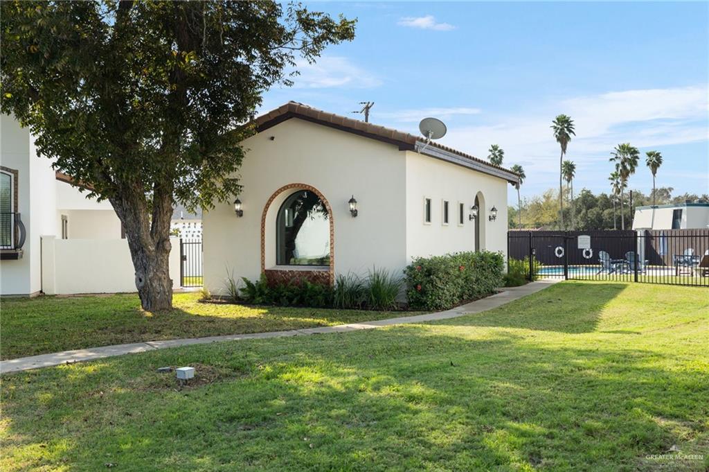 605 Ithaca Avenue McAllen, TX 78501 - Photo 18 of 23 a front view of a house with swimming pool and yard