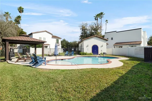 a view of a house with swimming pool and sitting area