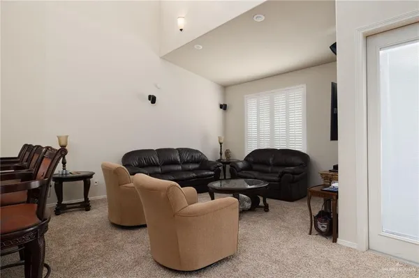 a living room with furniture and a air conditioner vent