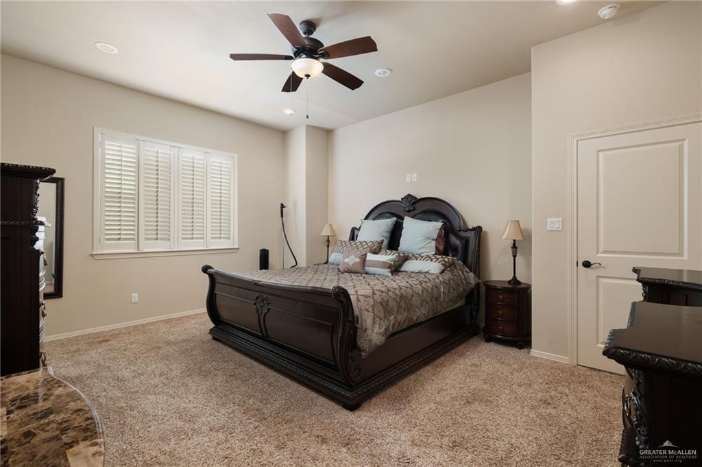 605 Ithaca Avenue McAllen, TX 78501 - Photo 8 of 23 a bedroom with a bed and a chandelier