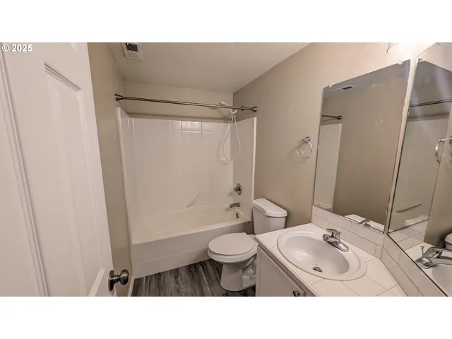 a bathroom with a sink toilet a mirror and shower