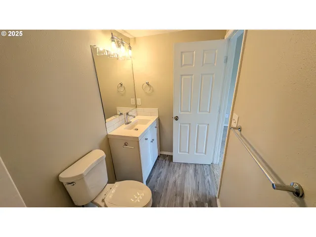 a bathroom with a sink toilet and a mirror