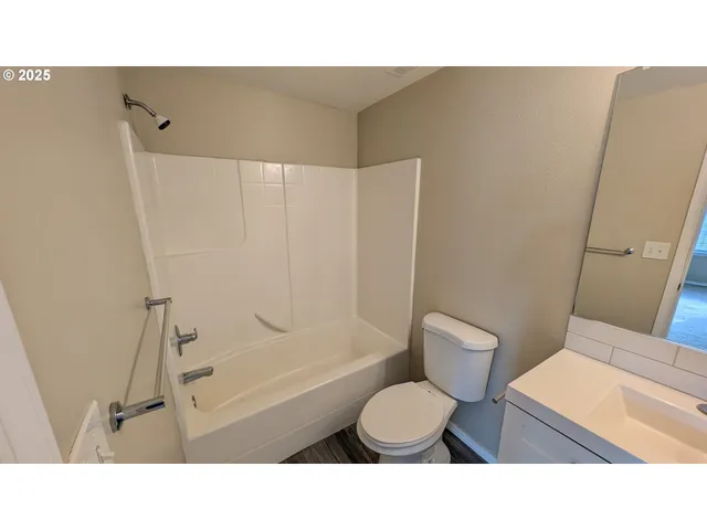 a bathroom with a toilet a sink and a shower