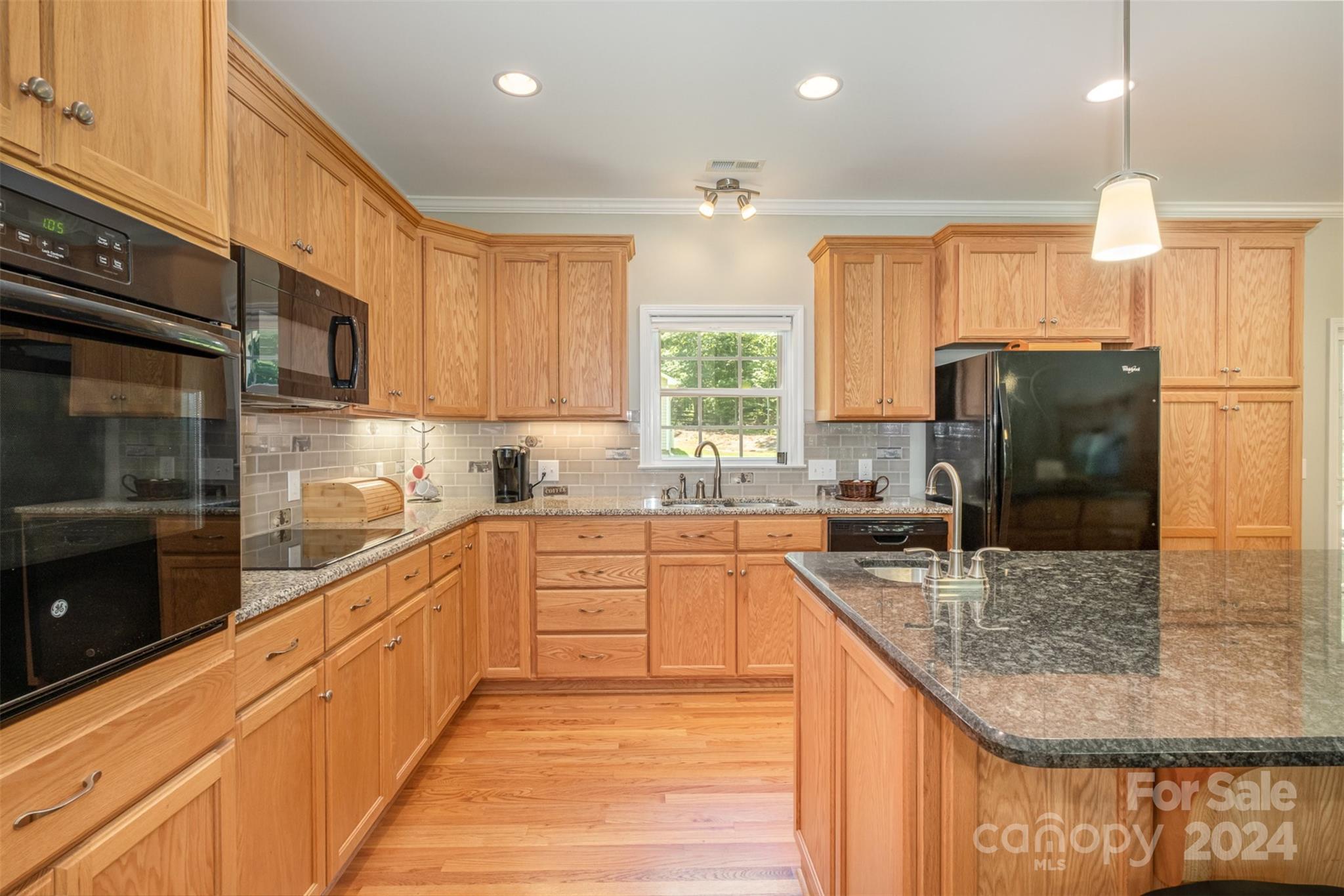 218 Old Hickory Road Locust, NC 28097 - Photo 12 of 38 a kitchen with stainless steel appliances granite countertop a refrigerator a sink dishwasher a stove and white cabinets with wooden floor