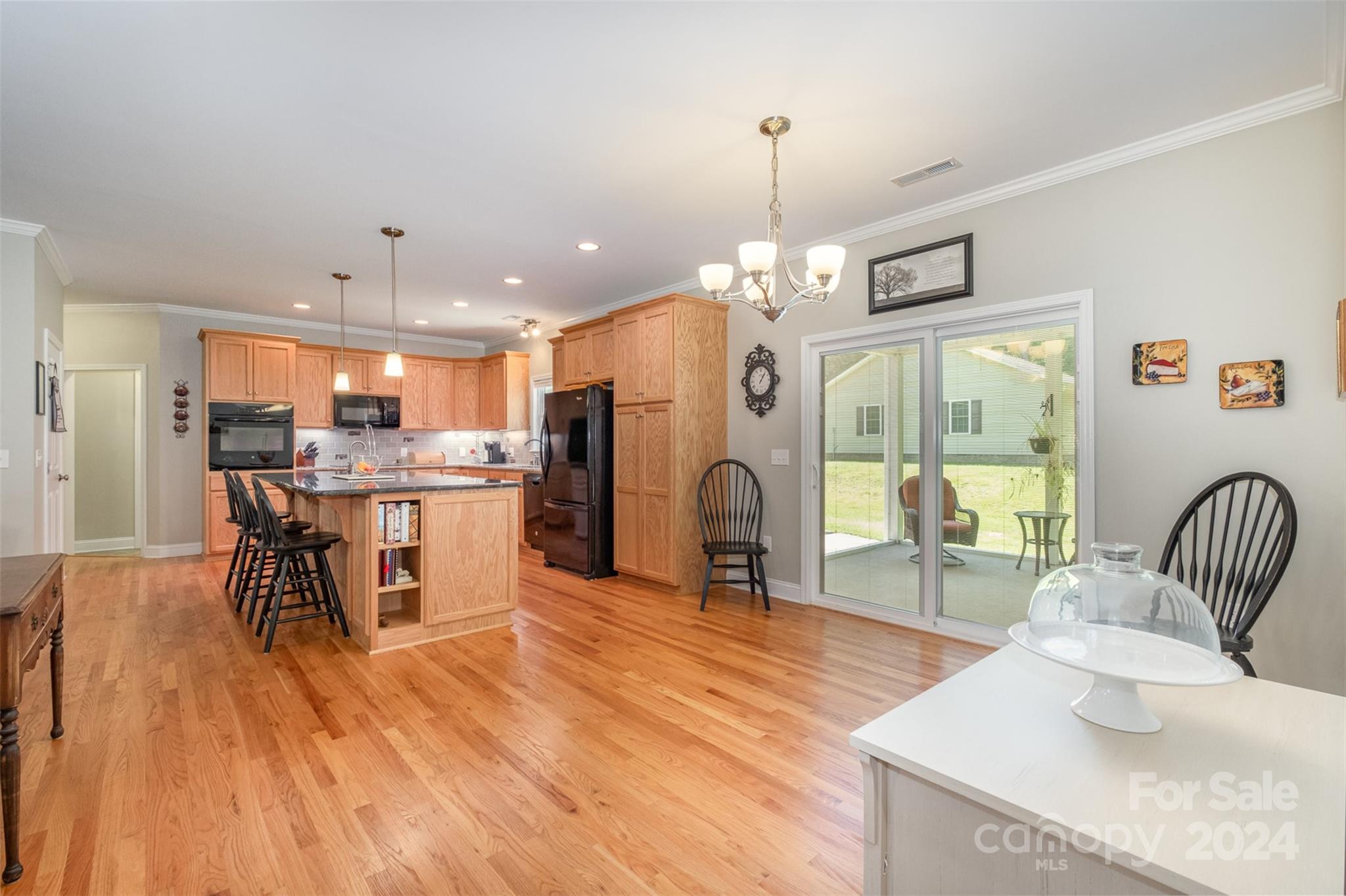 218 Old Hickory Road Locust, NC 28097 - Photo 13 of 38 a dining room with stainless steel appliances kitchen island granite countertop a dining table chairs and a living room view