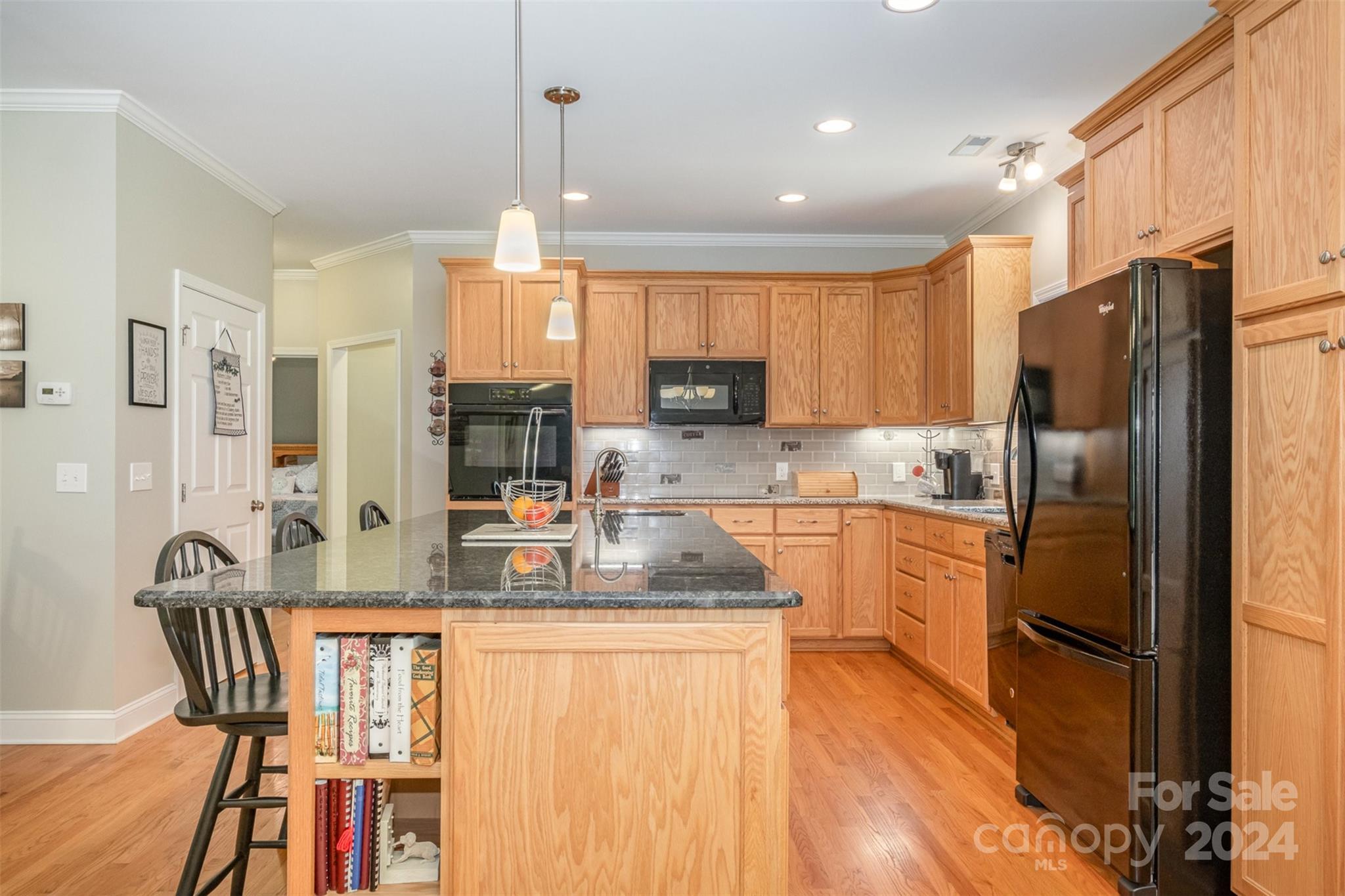 218 Old Hickory Road Locust, NC 28097 - Photo 14 of 38 a kitchen with stainless steel appliances granite countertop a refrigerator a stove top oven a sink dishwasher and a refrigerator with wooden floor