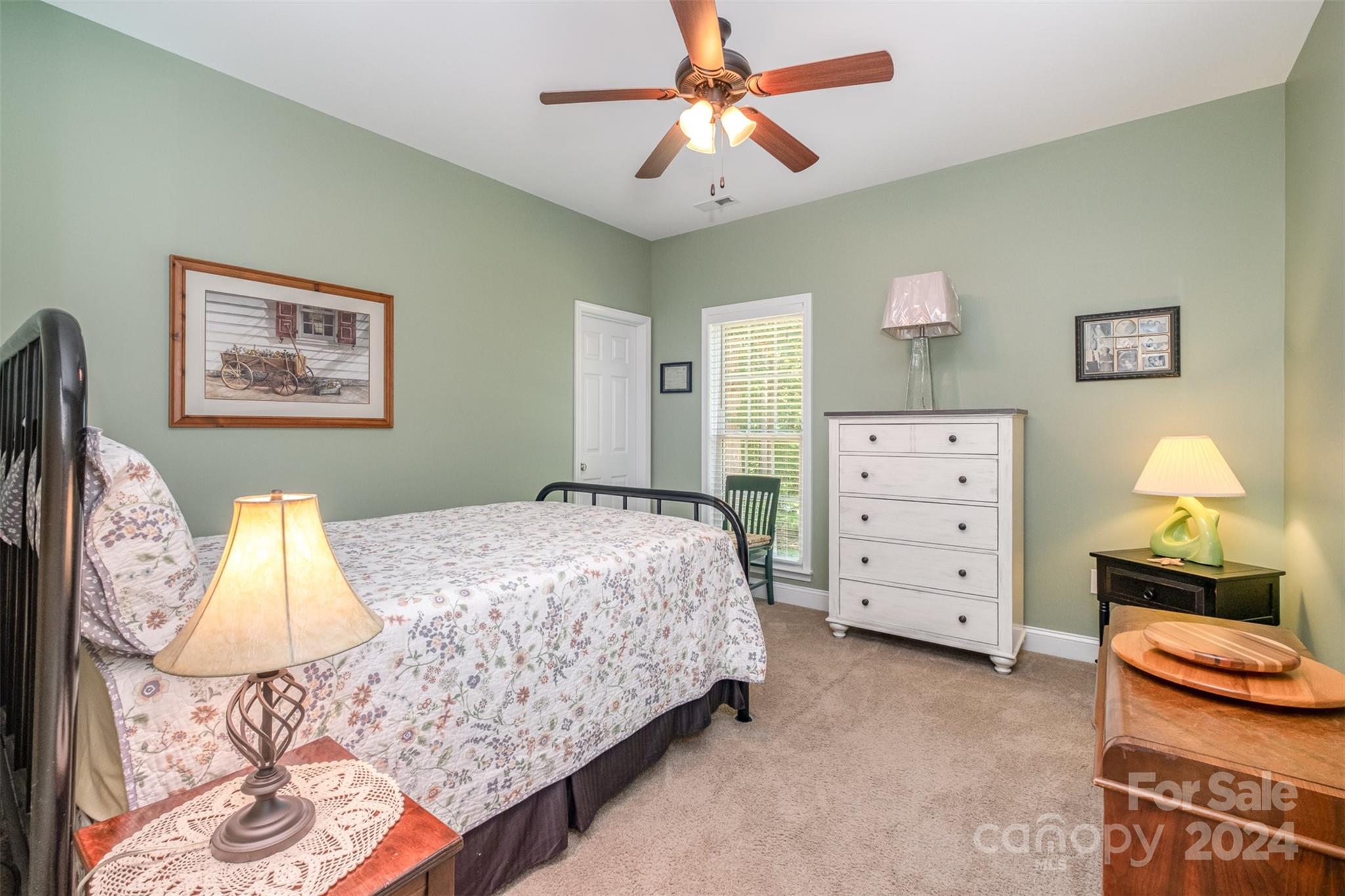 218 Old Hickory Road Locust, NC 28097 - Photo 23 of 38 a bedroom with a bed and a chandelier
