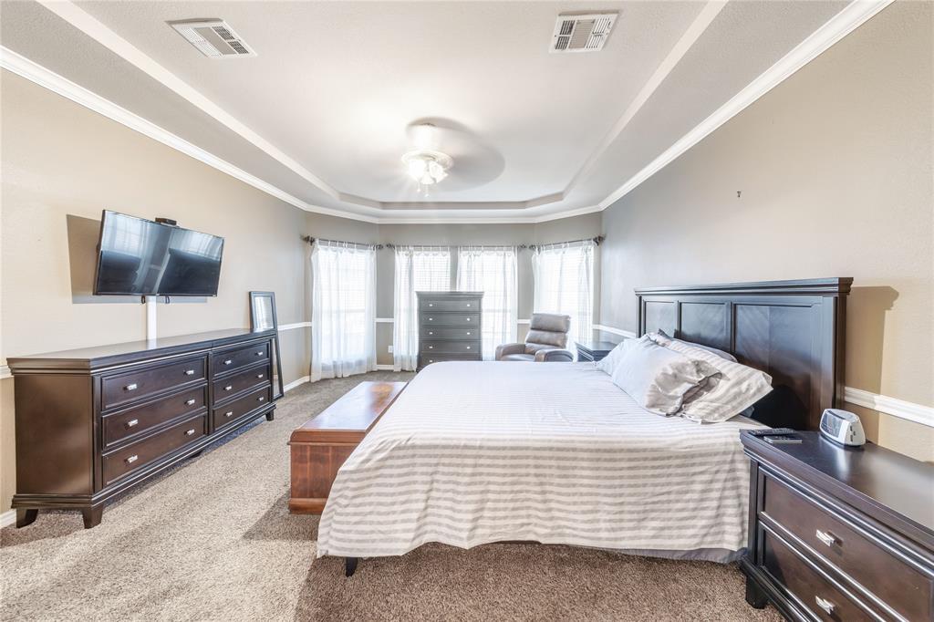 8001 St Fillans Lane Rowlett, TX 75089 - Photo 11 of 40 a bedroom with a bed and a flat screen tv