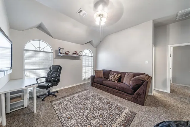 a living room with furniture rug and window