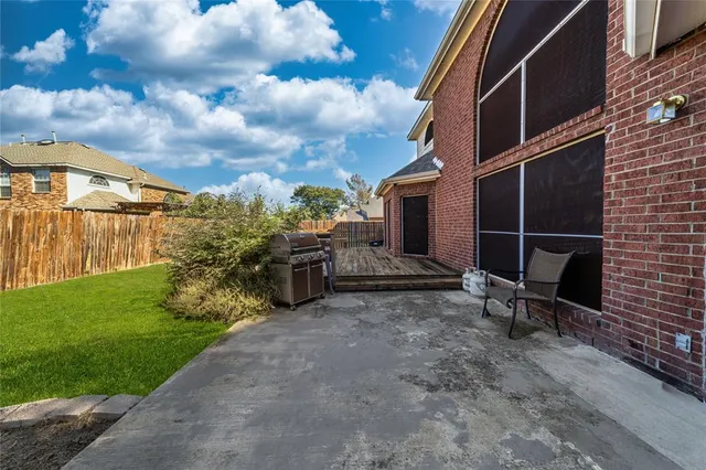 a view of a chair and table in backyard of the house