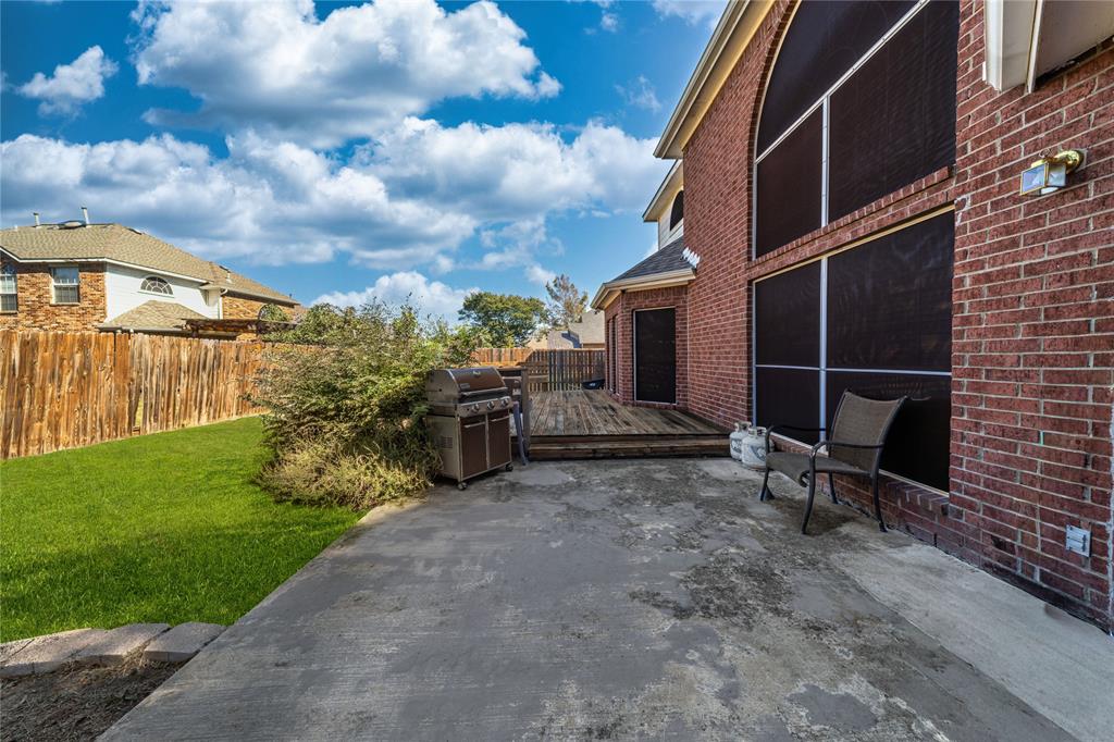 8001 St Fillans Lane Rowlett, TX 75089 - Photo 21 of 40 a view of a chair and table in backyard of the house