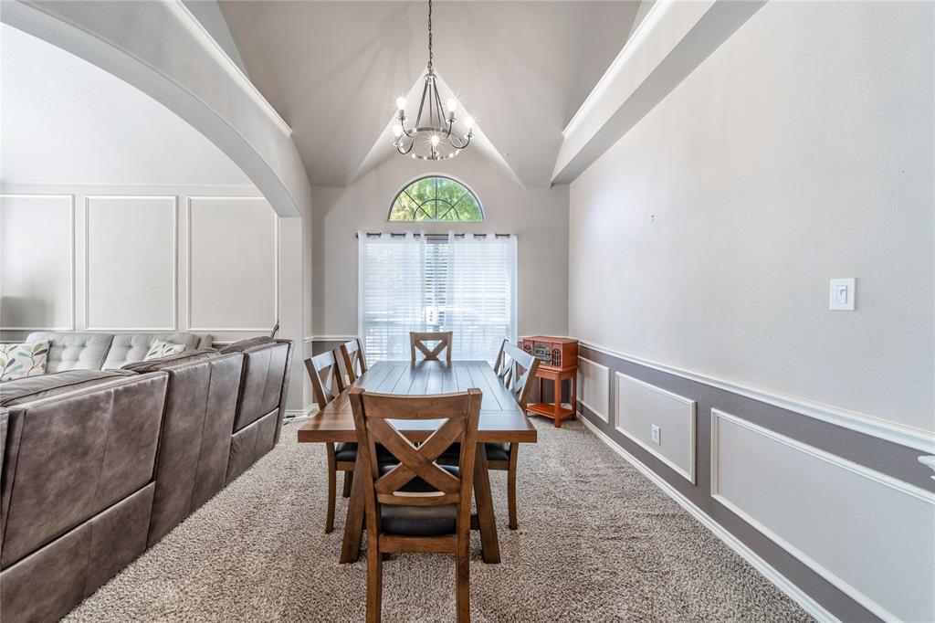 8001 St Fillans Lane Rowlett, TX 75089 - Photo 22 of 40 a view of a dining room with furniture a chandelier and wooden floor