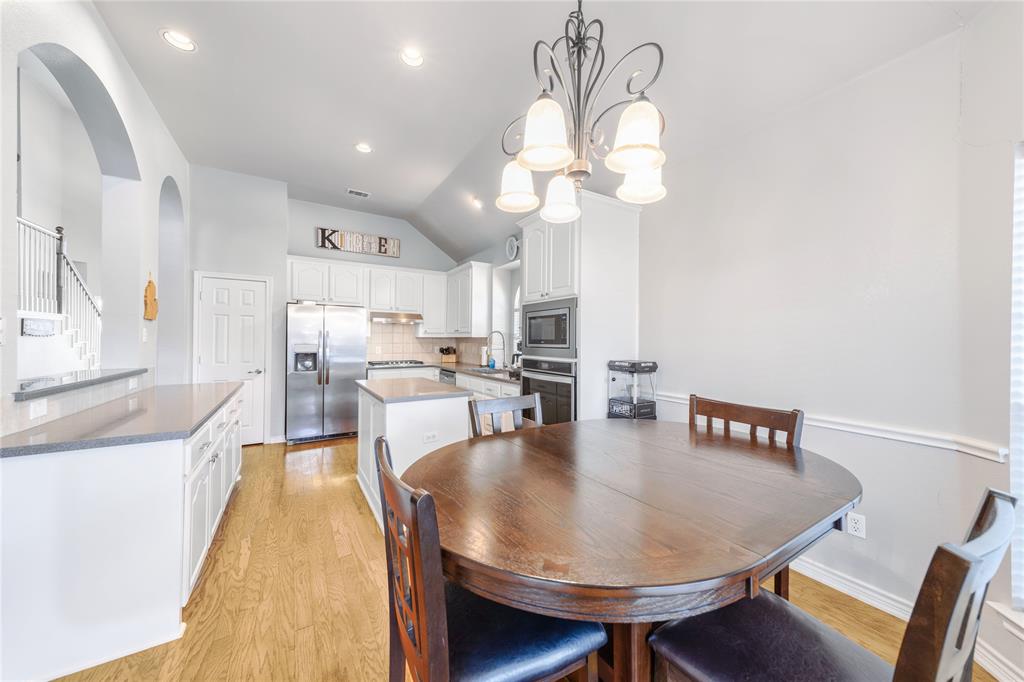8001 St Fillans Lane Rowlett, TX 75089 - Photo 24 of 40 a view of a dining room with furniture and wooden floor