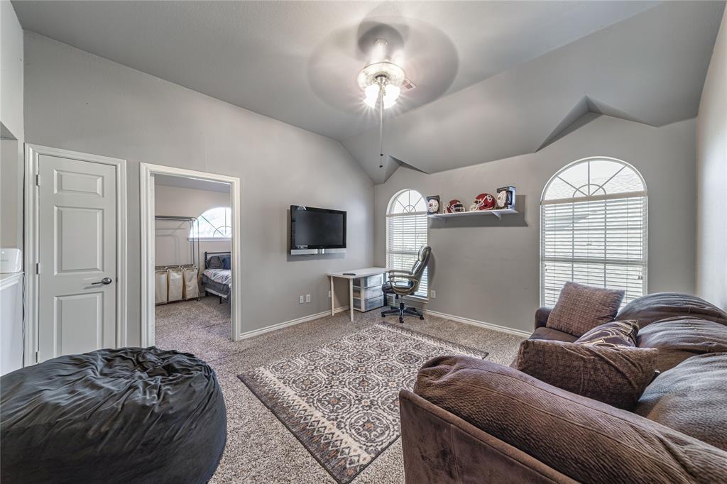 8001 St Fillans Lane Rowlett, TX 75089 - Photo 29 of 40 a living room with furniture a window and a flat screen tv