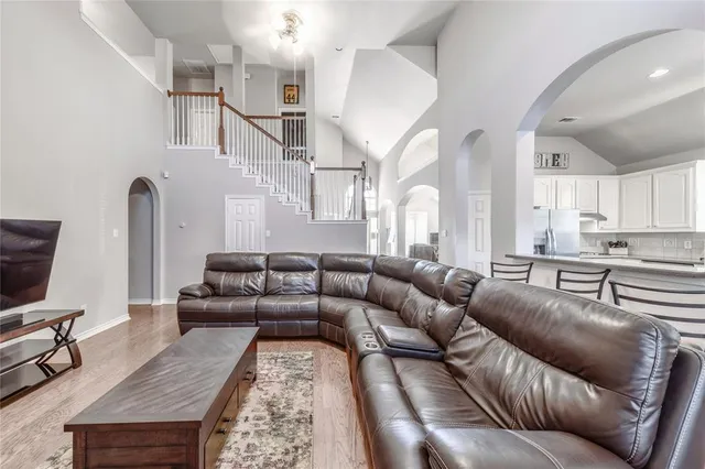 a living room with furniture or kitchen view and a wooden floor