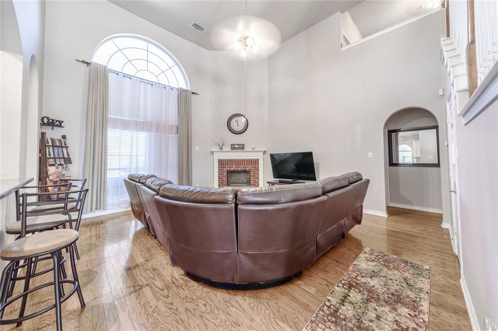 8001 St Fillans Lane Rowlett, TX 75089 - Photo 36 of 40 a living room with furniture and a fireplace