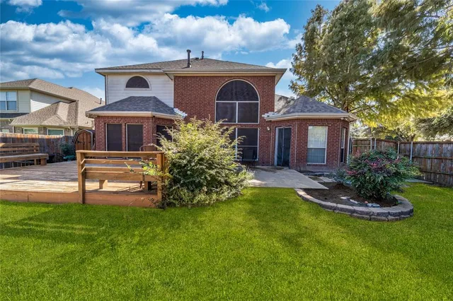 a front view of a house with a yard table and chairs