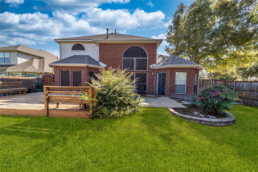 8001 St Fillans Lane Rowlett, TX 75089 - Photo 38 of 40 a front view of a house with a yard table and chairs
