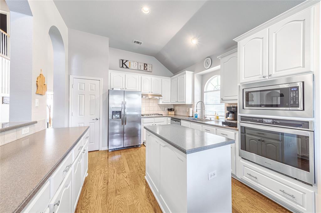 8001 St Fillans Lane Rowlett, TX 75089 - Photo 4 of 40 a kitchen with granite countertop a sink stove and refrigerator