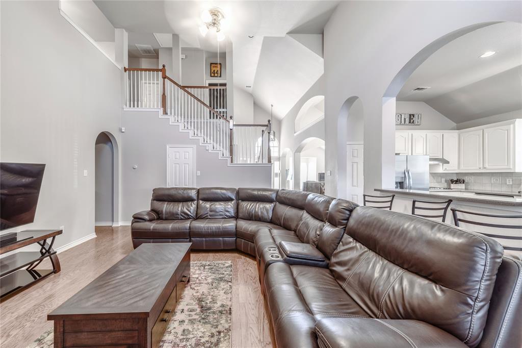 8001 St Fillans Lane Rowlett, TX 75089 - Photo 6 of 40 a living room with furniture or kitchen view and a wooden floor
