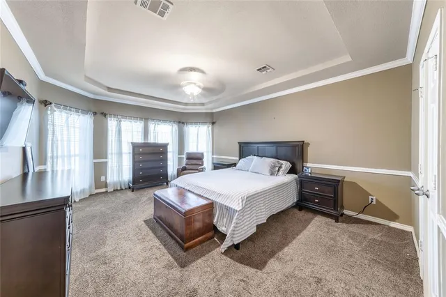a spacious bedroom with a bed and large cabinets