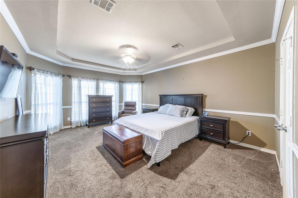 8001 St Fillans Lane Rowlett, TX 75089 - Photo 10 of 40 a spacious bedroom with a bed and large cabinets