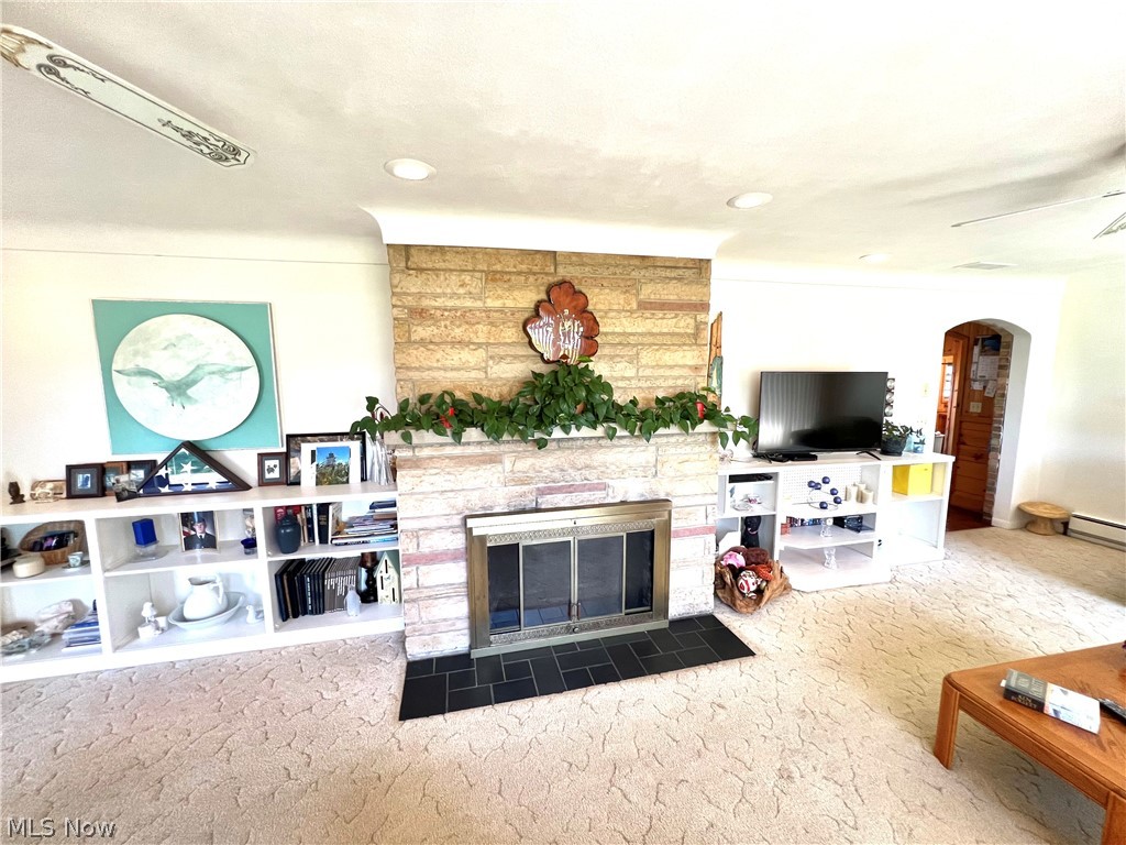 4663 East Harbor Road Port Clinton, OH 43452 - Photo 8 of 31 Living room with a stone fireplace and dark carpet
