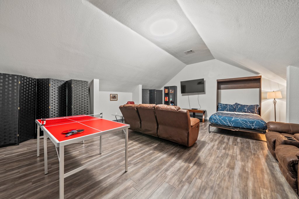 209 Lakeview Circle Spring Branch, TX 78070 - Photo 26 of 40 Game room featuring lofted ceiling, a textured ceiling, visible vents, and wood finished floors