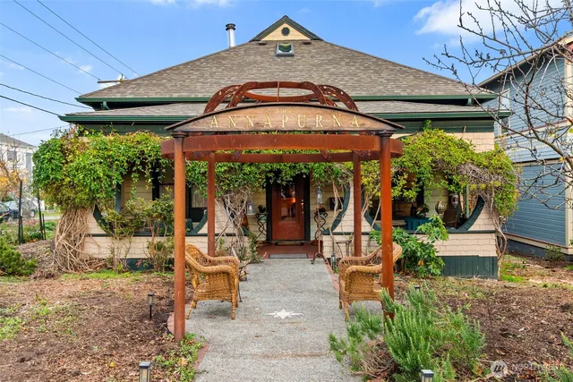 a view of a patio with table and chairs under an umbrella