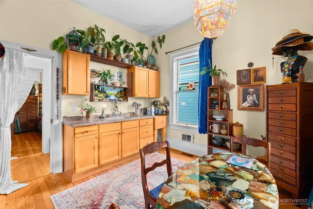 a bedroom with bed and wooden floor