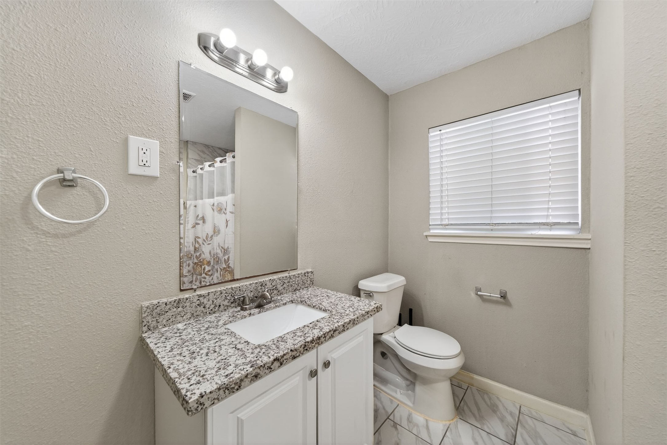 1107 Christine Street Houston, TX 77017 - Photo 13 of 22 a bathroom with a granite countertop sink toilet and mirror