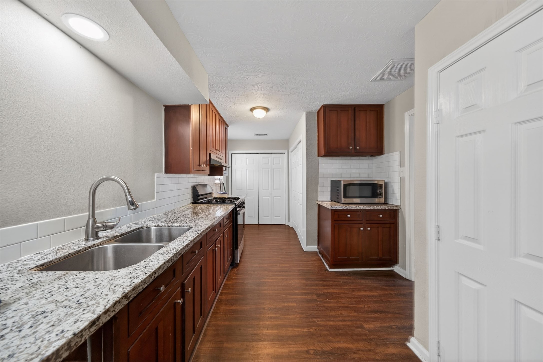 1107 Christine Street Houston, TX 77017 - Photo 2 of 22 a kitchen with stainless steel appliances granite countertop a sink stove and refrigerator
