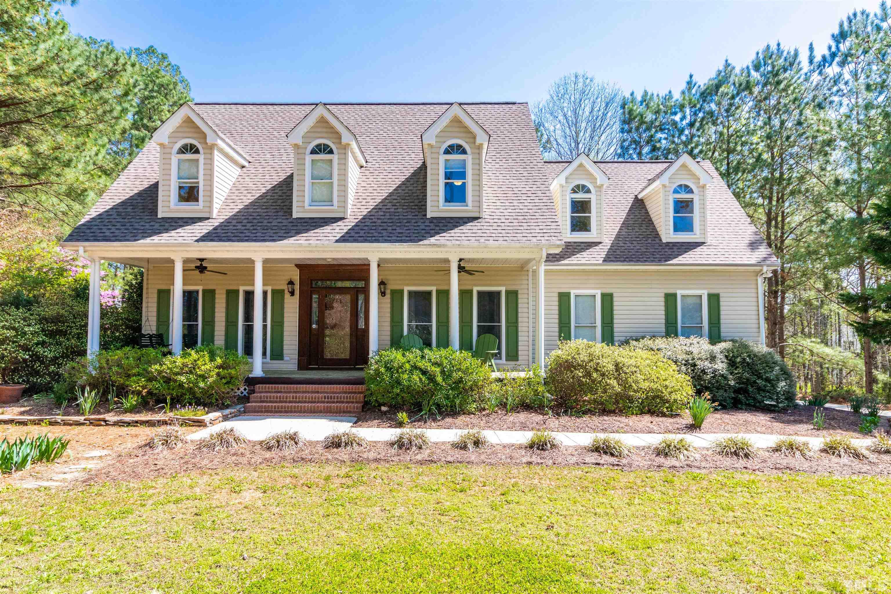 120 Kelsey Court Clayton, NC 27520 - Photo 1 of 62 a front view of a house with a yard table and chairs