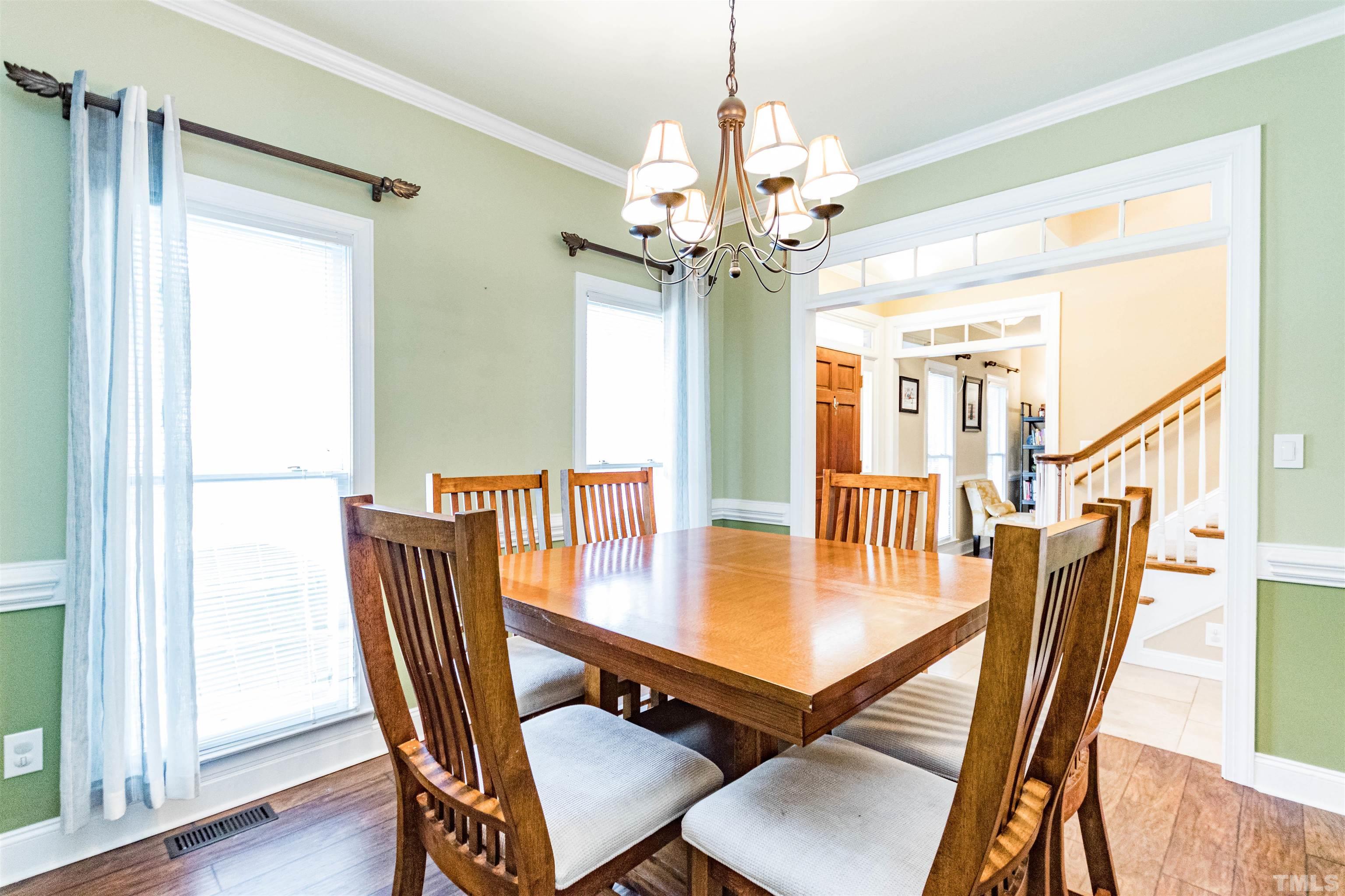 120 Kelsey Court Clayton, NC 27520 - Photo 14 of 62 a view of a dining room with furniture a chandelier and wooden floor