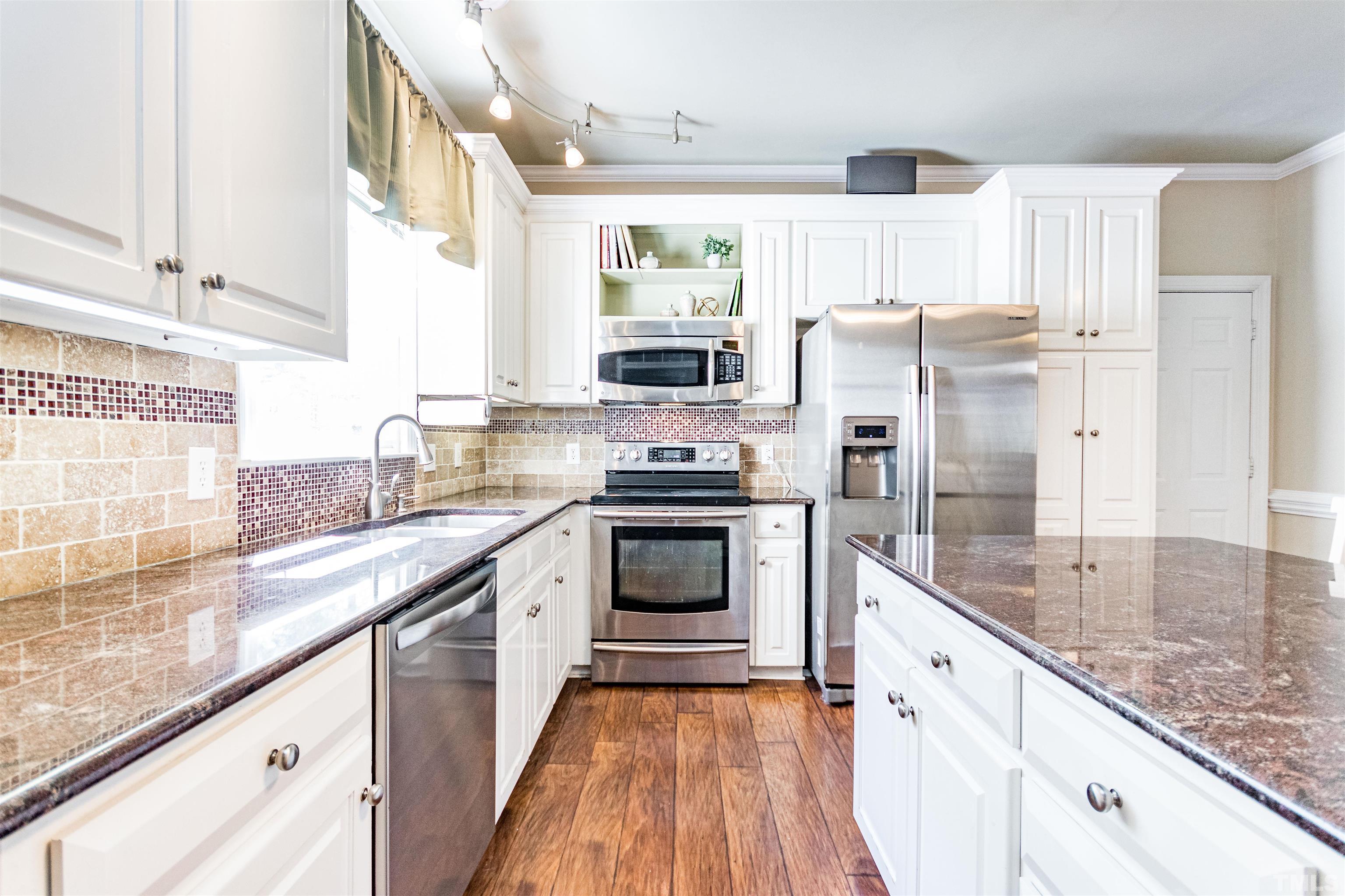 120 Kelsey Court Clayton, NC 27520 - Photo 19 of 62 a kitchen with stainless steel appliances granite countertop a refrigerator and a sink