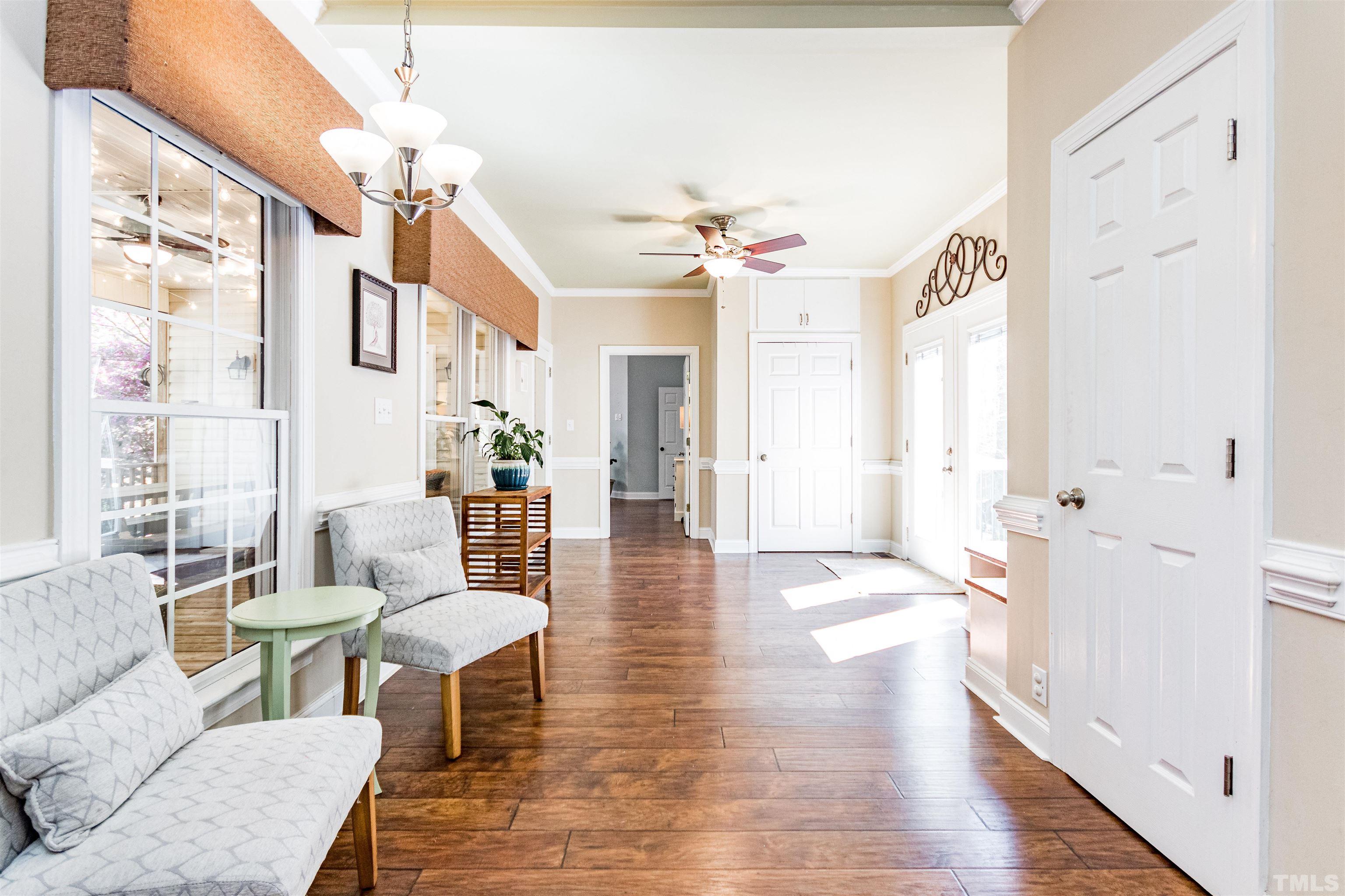 120 Kelsey Court Clayton, NC 27520 - Photo 21 of 62 a living room with furniture and a chandelier