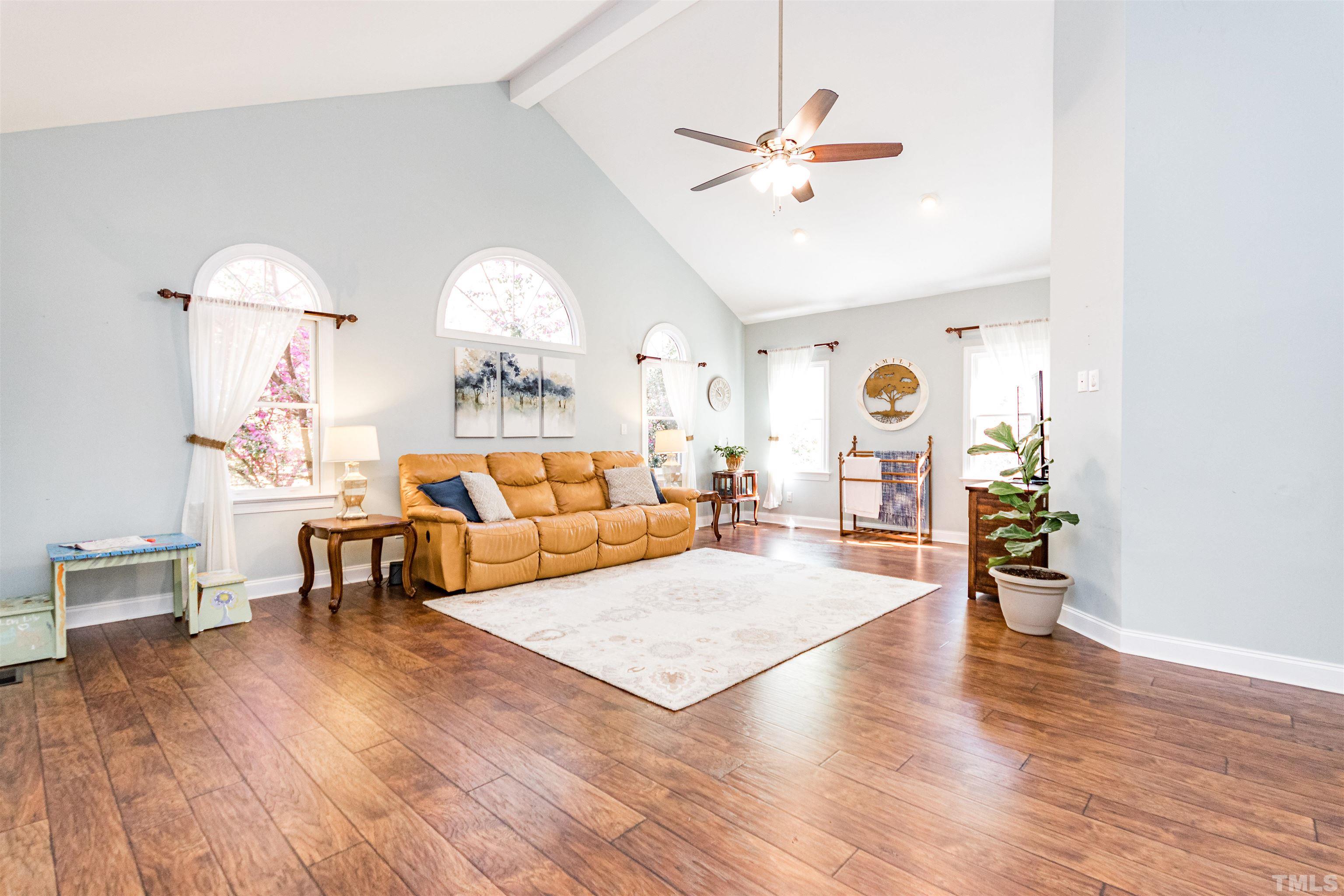 120 Kelsey Court Clayton, NC 27520 - Photo 24 of 62 a living room with furniture and a chandelier