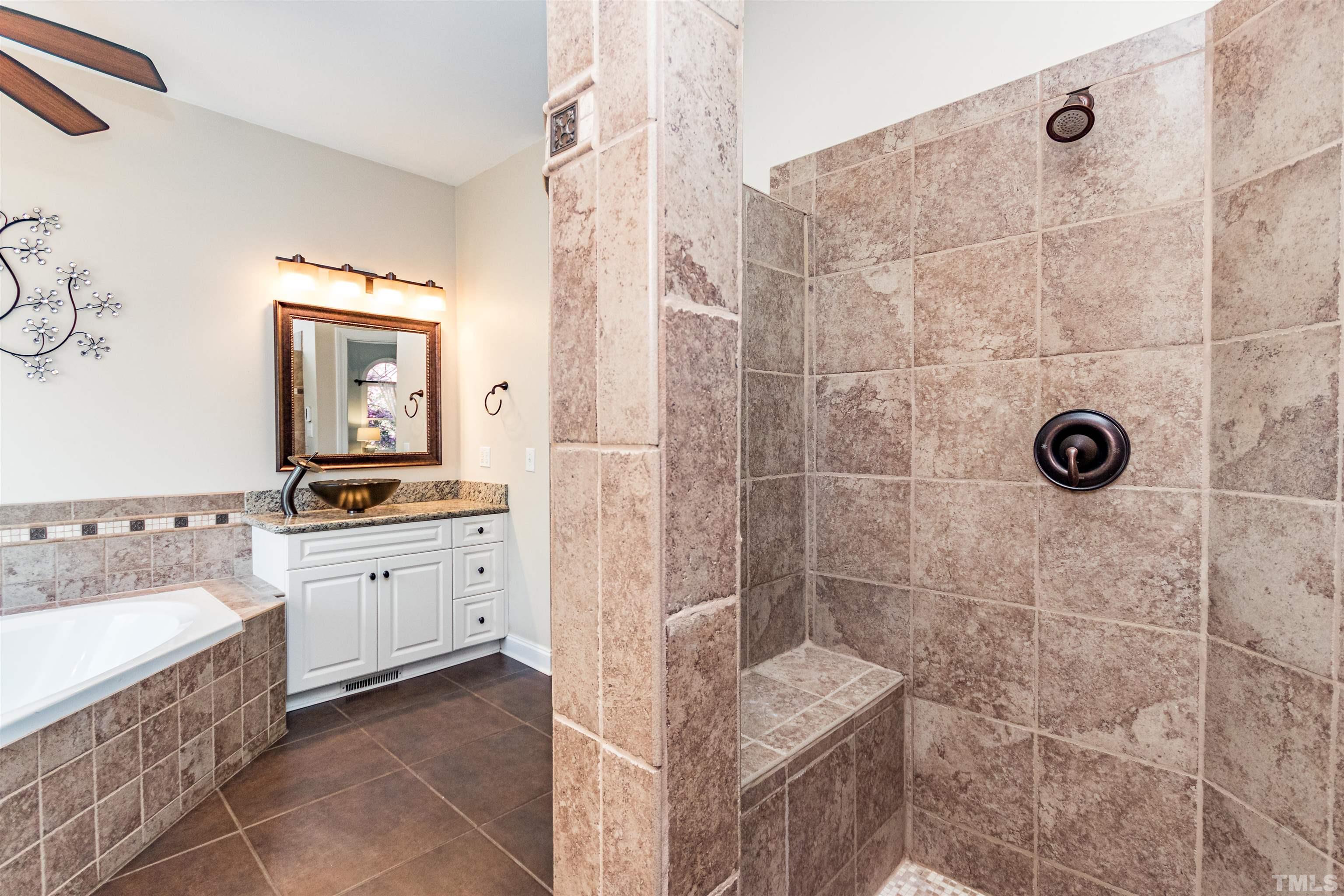 120 Kelsey Court Clayton, NC 27520 - Photo 30 of 62 a bathroom with a granite countertop sink a toilet a mirror and shower