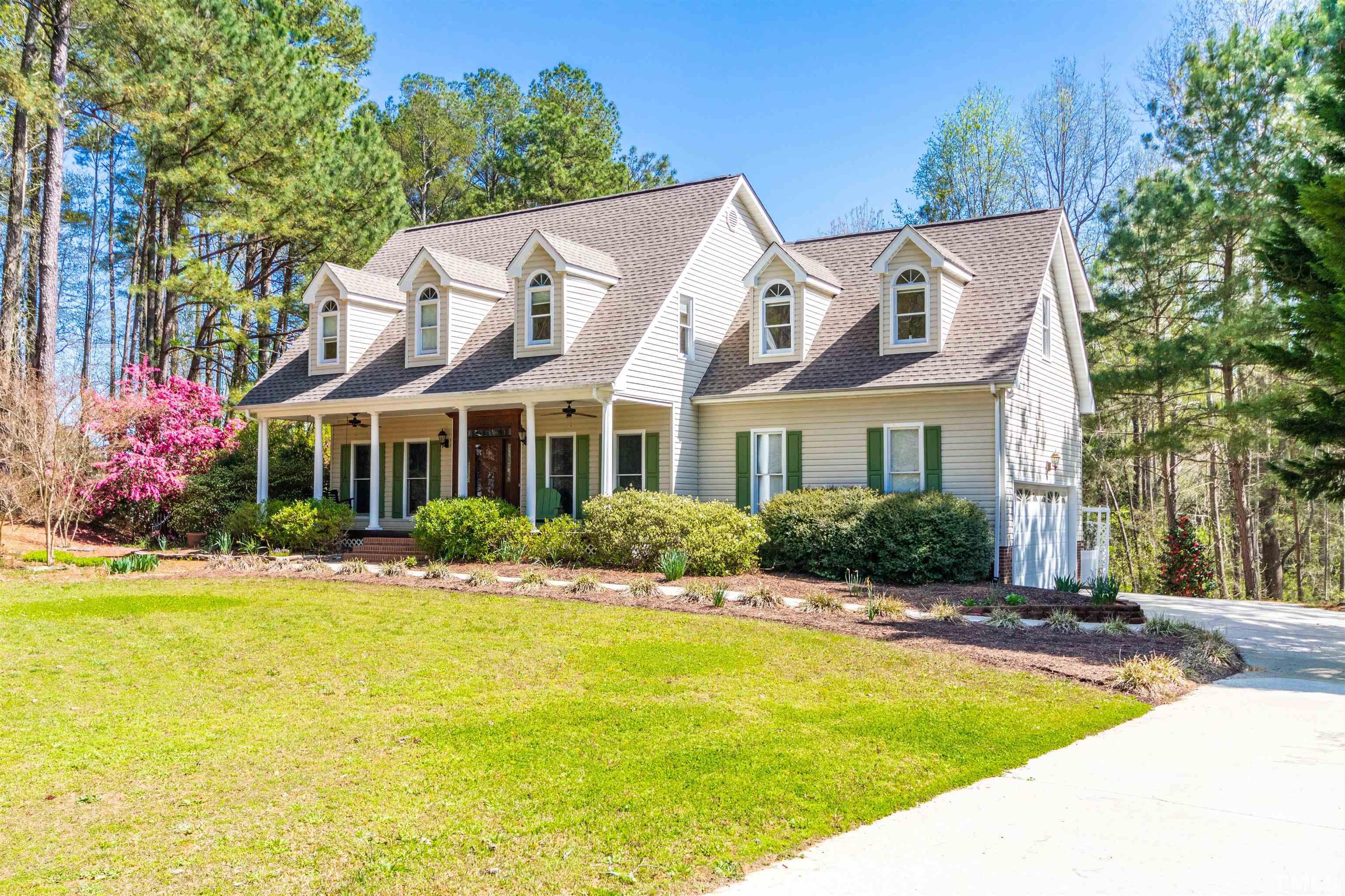 120 Kelsey Court Clayton, NC 27520 - Photo 3 of 62 a view of house with yard outdoor seating and covered with trees