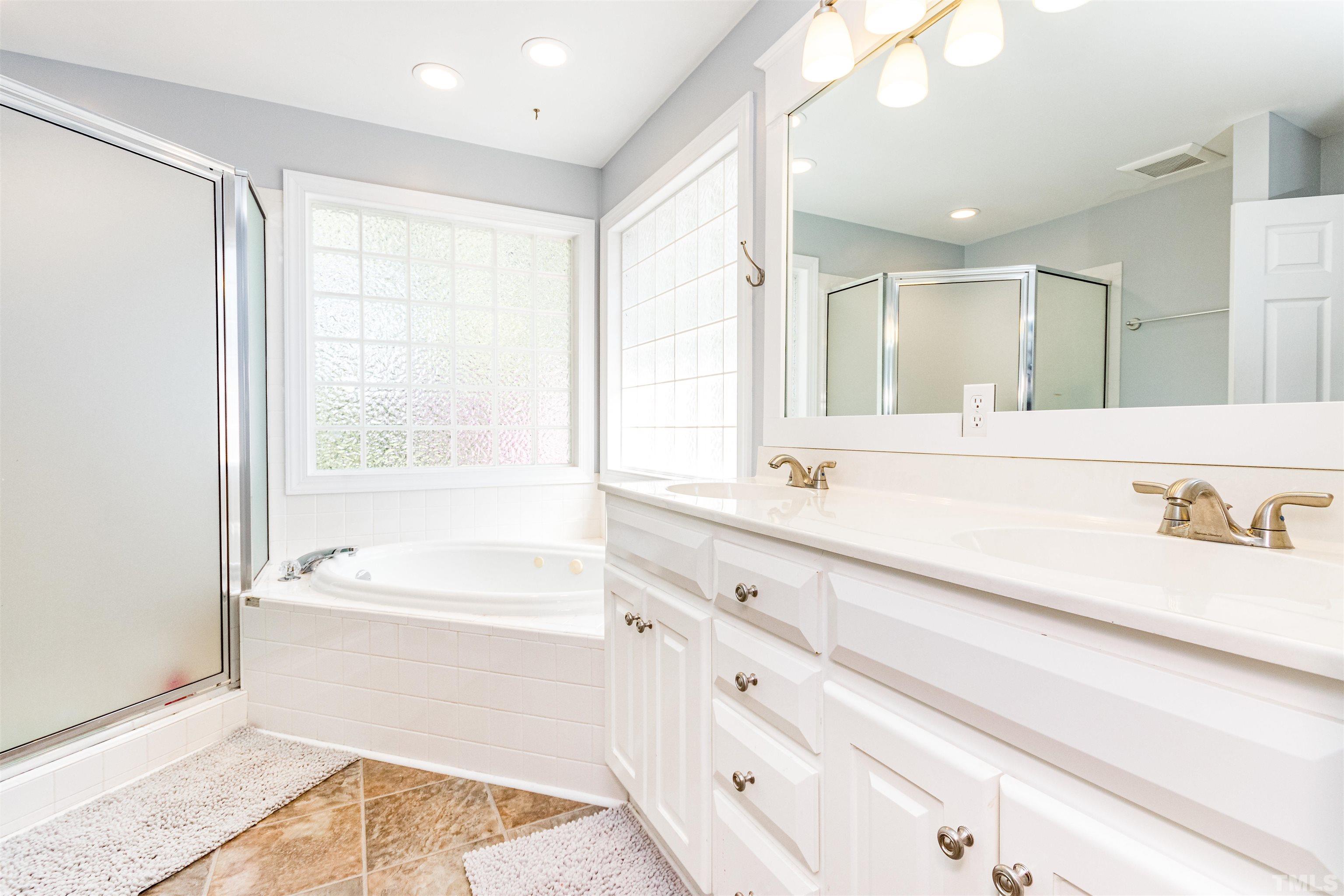 120 Kelsey Court Clayton, NC 27520 - Photo 34 of 62 a bathroom with a bathtub a sink and a window