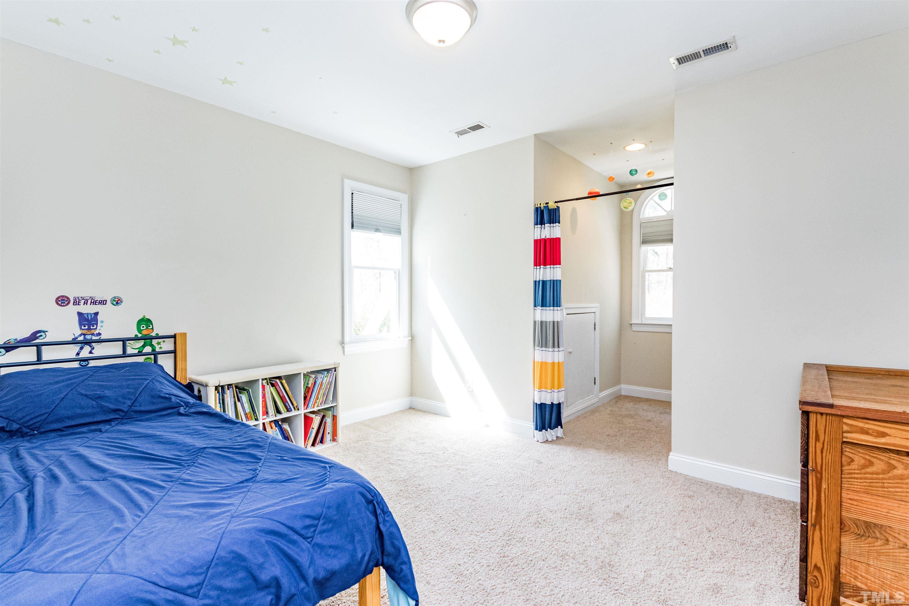 120 Kelsey Court Clayton, NC 27520 - Photo 35 of 62 a bedroom with a bed and a large window