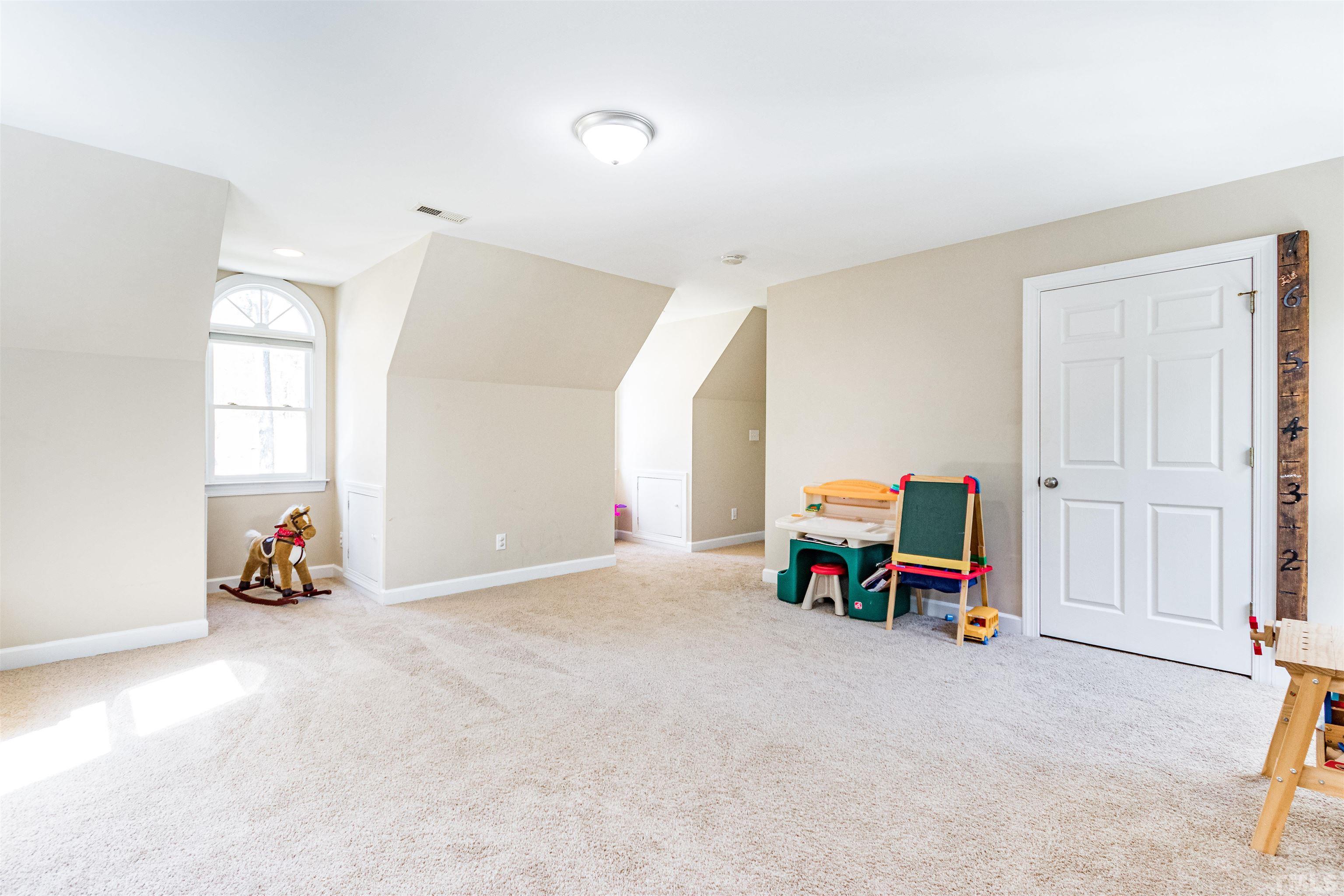 120 Kelsey Court Clayton, NC 27520 - Photo 37 of 62 an empty room with furniture and a window