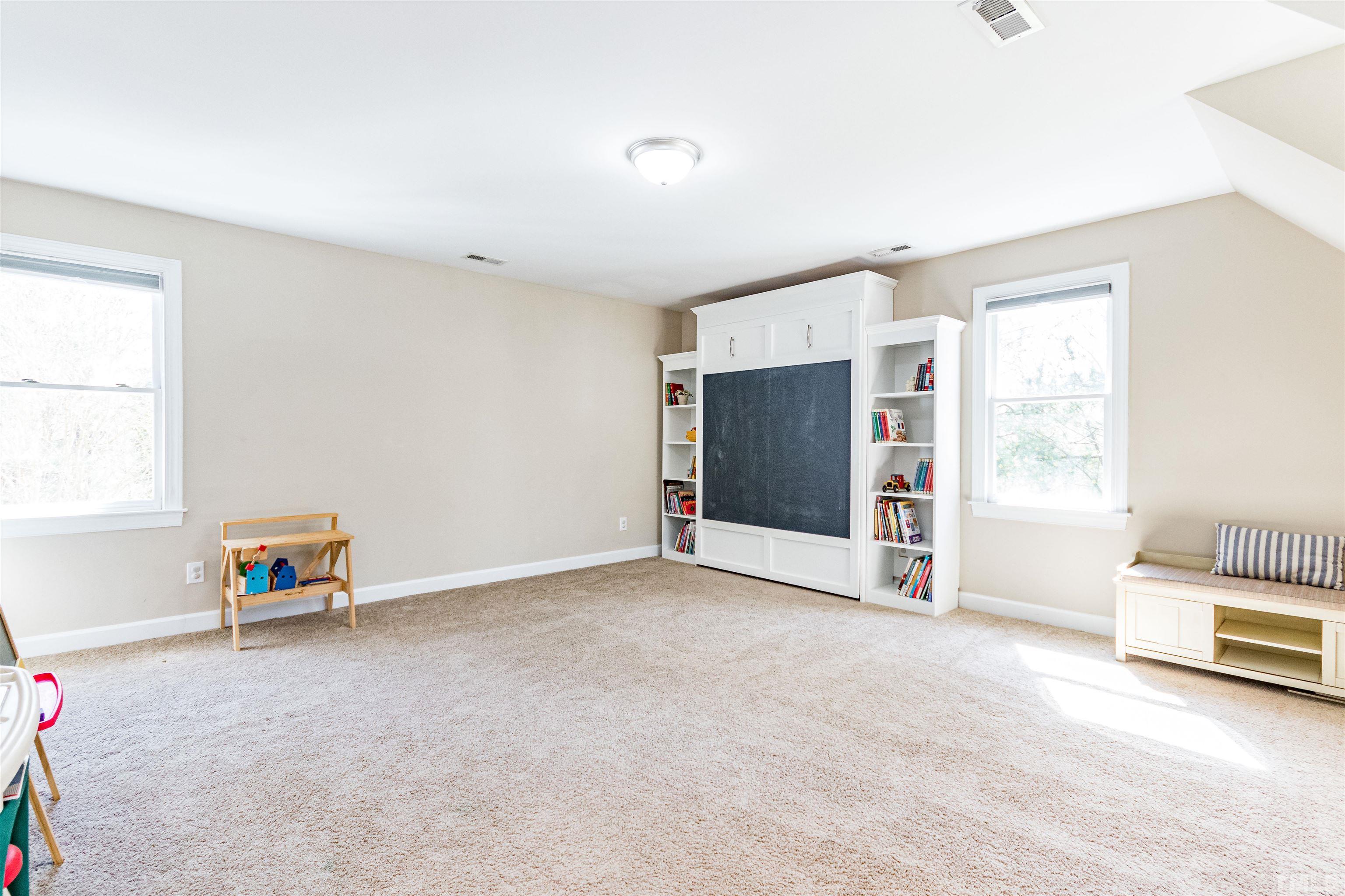120 Kelsey Court Clayton, NC 27520 - Photo 38 of 62 a view of an empty room with a window and a kitchen