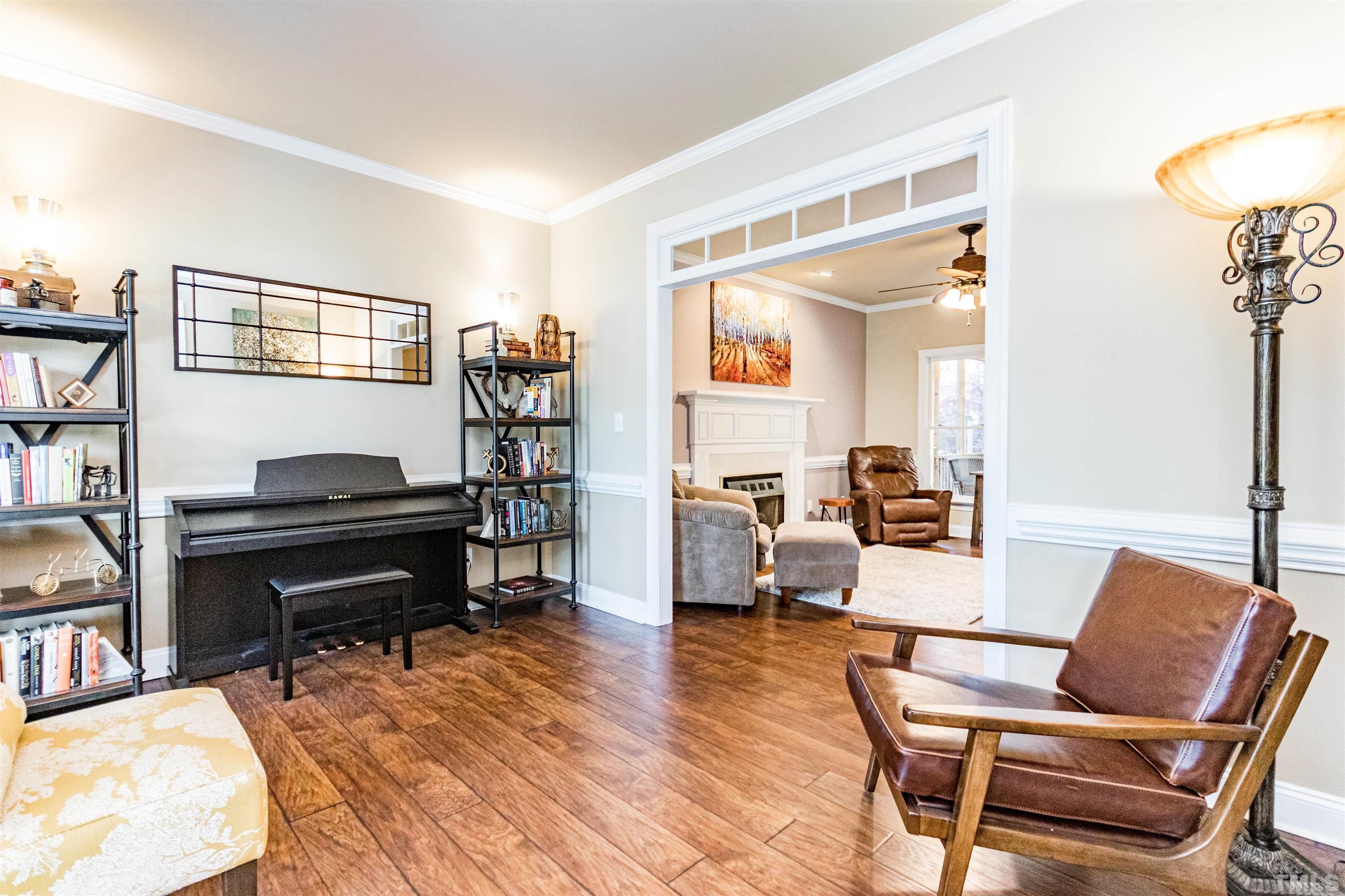 120 Kelsey Court Clayton, NC 27520 - Photo 8 of 62 a living room with furniture and a wooden floor