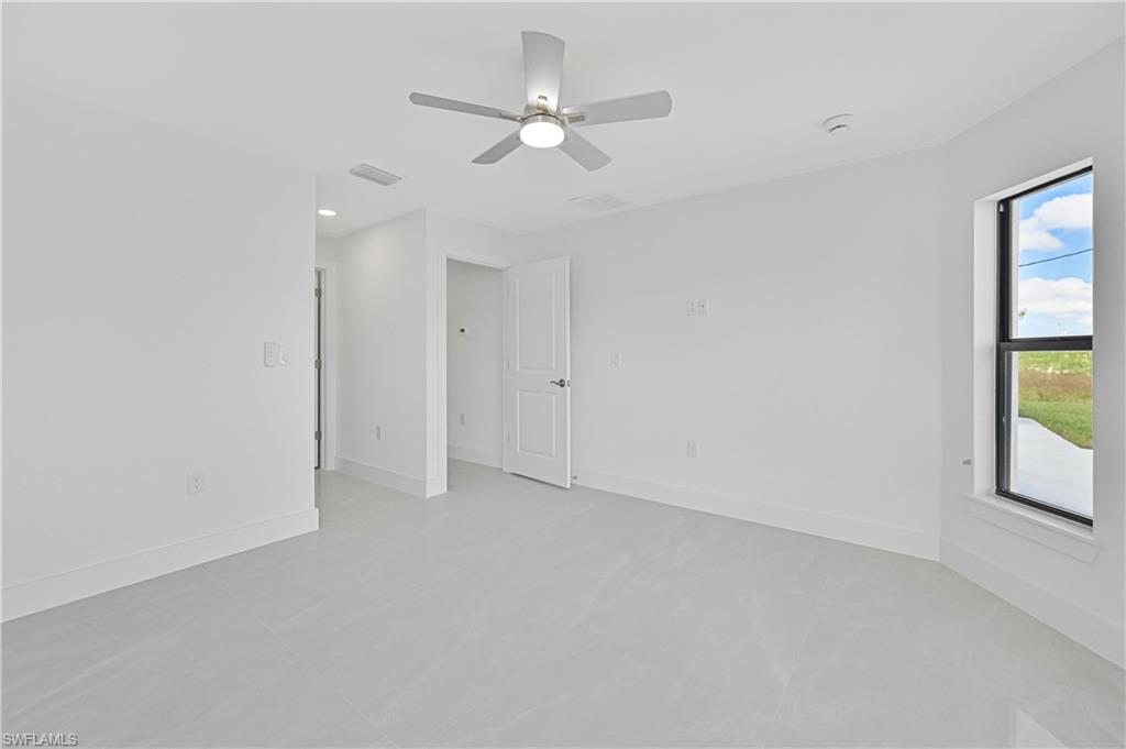4709-4711 27th Street Southwest Lehigh Acres, FL 33973 - Photo 13 of 21 Spare room with a ceiling fan and finished concrete flooring