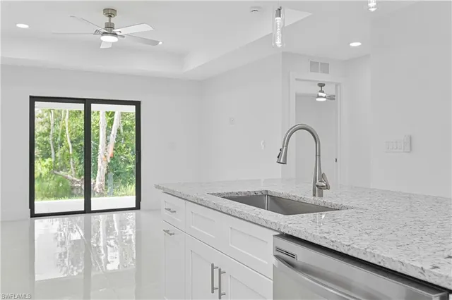 a kitchen with a sink and chandelier