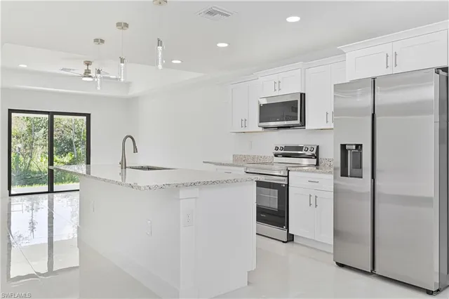 a kitchen with a refrigerator and a sink
