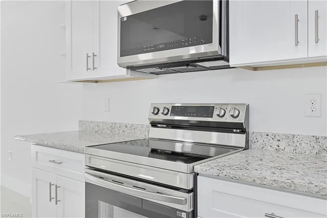 a kitchen with appliances cabinets and a counter top space